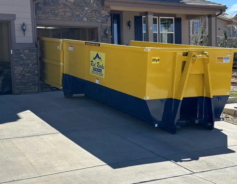 20 yard roll-off dumpster placed in a residential Denver driveway